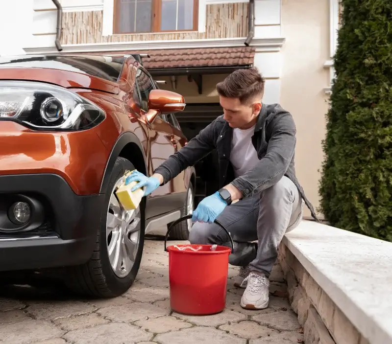 Lavage auto à domicile Cambremer : professionnel intervenant sur un véhicule